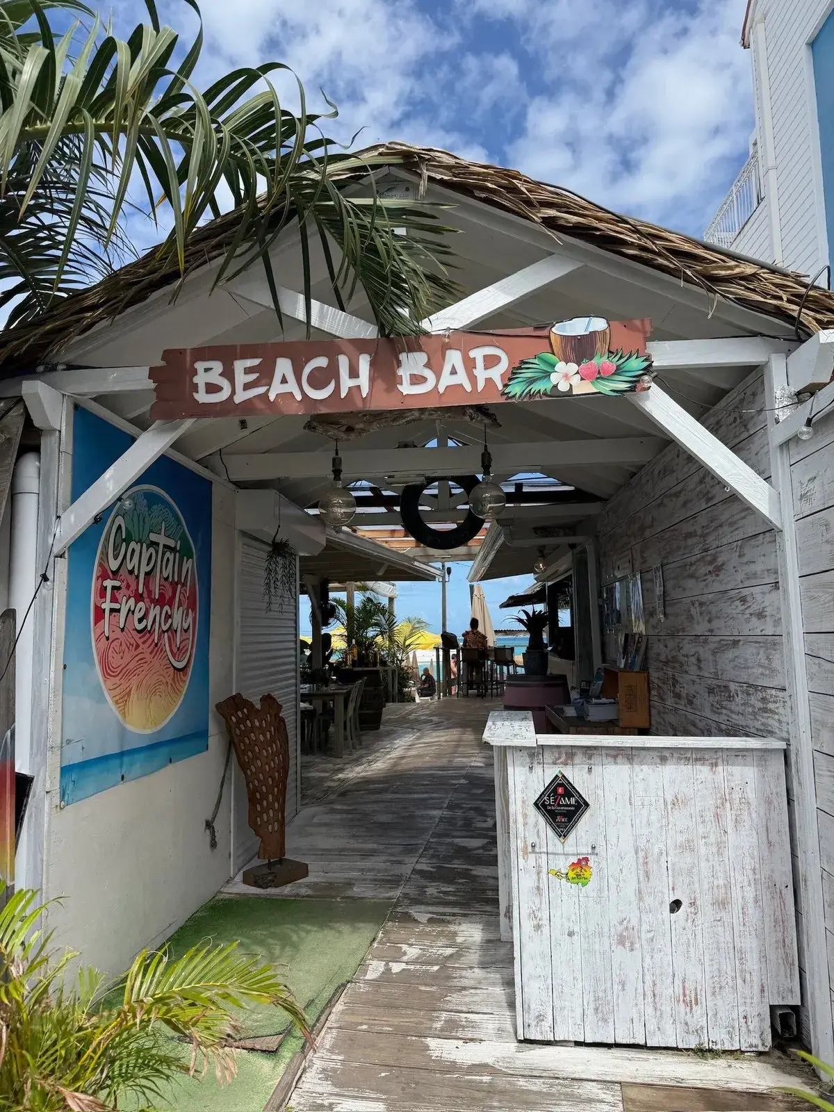 Captain Frenchy à Grand Case - entrée du beach bar avec enseigne en bois et accès direct à la plage